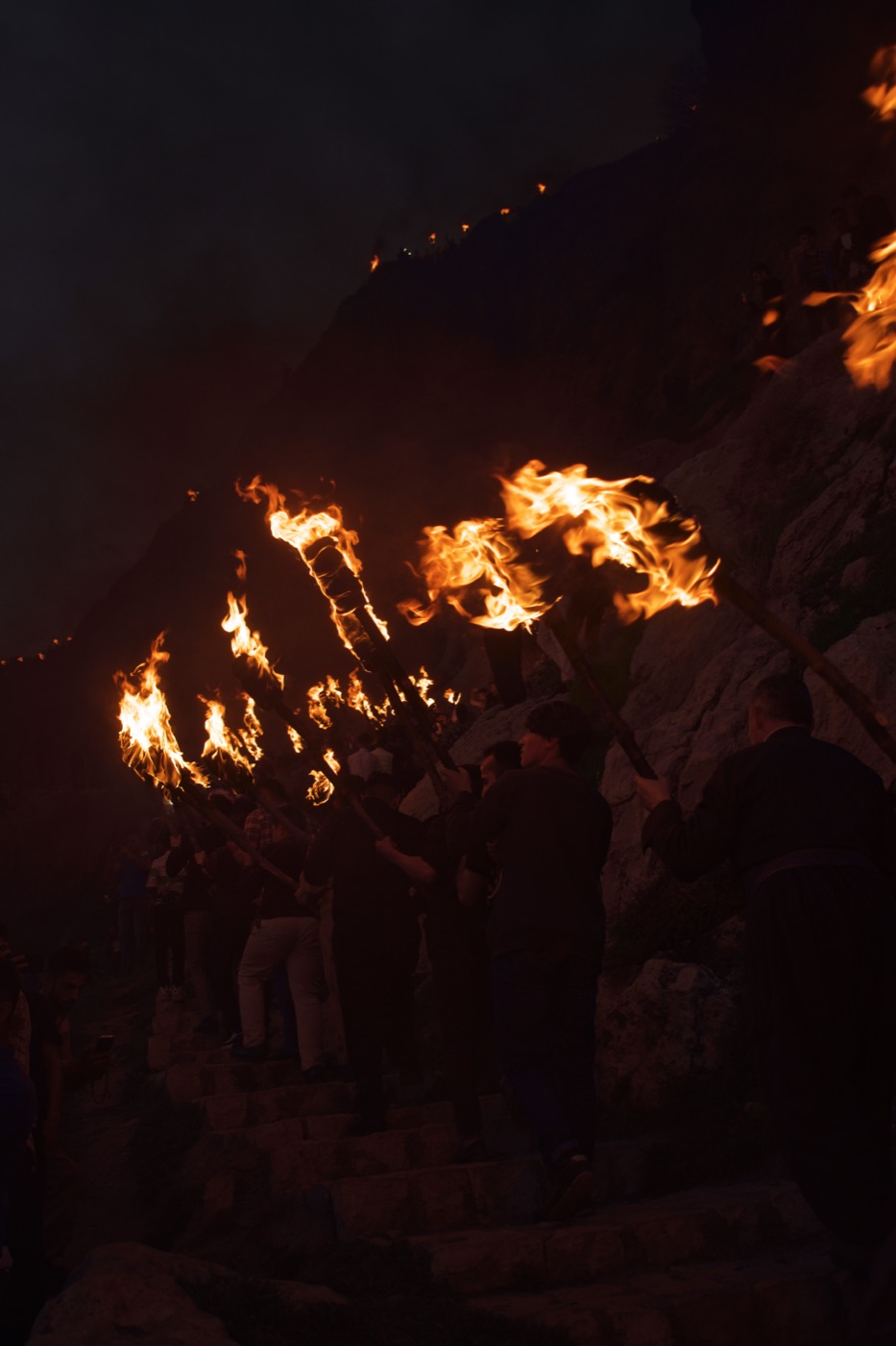The Newroz torch procession climbing the mountainside at Akre